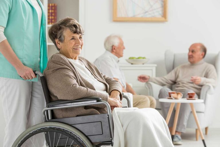 Adult child and older parent reviewing care options together at a kitchen table.